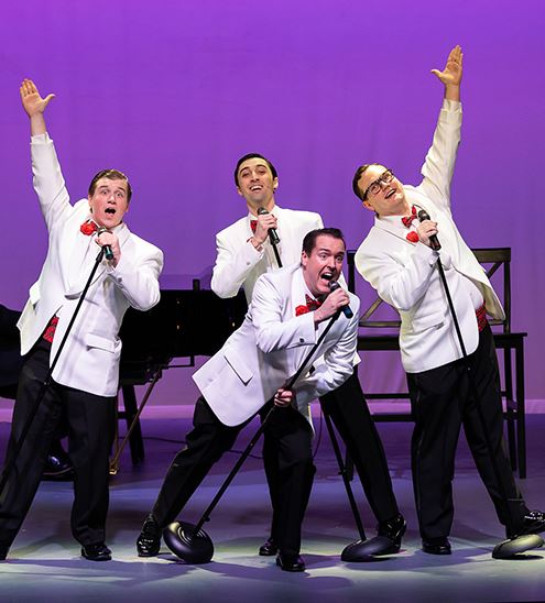 Forever Plaid cast with plungers on stage